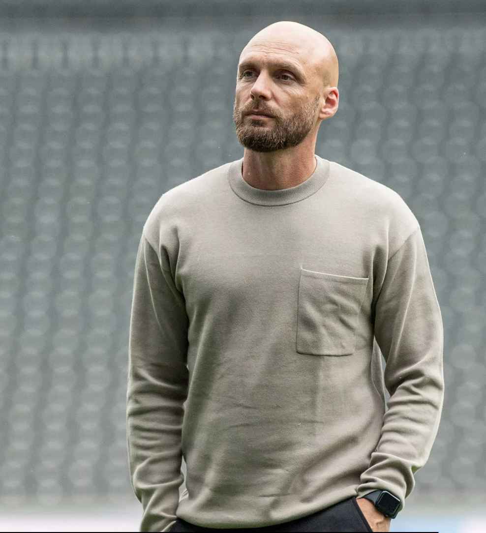 Sportdirektor Ole Book, mit SmartWatch am Handgelenk..